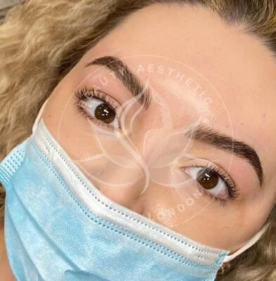 Detailed view of microblading eyebrows, highlighting the natural-looking, perfectly shaped brow strokes created with precision