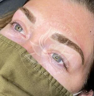 Detailed view of microblading eyebrows, highlighting the natural-looking, perfectly shaped brow strokes created with precision